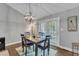Charming dining room features a modern chandelier and adjacent access to outdoor space at 1304 Rothes Rd, Cary, NC 27511