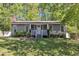 Charming home featuring a manicured front yard and a cozy front porch at 1304 Rothes Rd, Cary, NC 27511