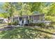 Charming home featuring a manicured front yard and a cozy front porch at 1304 Rothes Rd, Cary, NC 27511