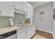 Well-lit kitchen with white cabinets, tile backsplash, and granite countertops at 1304 Rothes Rd, Cary, NC 27511