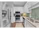 Modern kitchen featuring stainless steel appliances, light countertops, and tiled backsplash at 1304 Rothes Rd, Cary, NC 27511