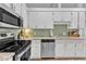 Bright kitchen featuring stainless steel appliances and light granite countertops at 1304 Rothes Rd, Cary, NC 27511