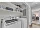 Modern laundry room featuring a side-by-side washer and dryer at 1304 Rothes Rd, Cary, NC 27511