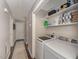 Convenient laundry area features modern washer and dryer with built-in storage shelving at 1304 Rothes Rd, Cary, NC 27511