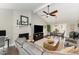 Open-concept living room with vaulted ceilings, fireplace, and hardwood floors leading to dining area at 1304 Rothes Rd, Cary, NC 27511