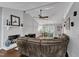 Cozy living room with a fireplace, ceiling fan, and a dining area at 1304 Rothes Rd, Cary, NC 27511