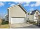 Attached garage with white door and a concrete driveway at 1619 Elegance Dr, Raleigh, NC 27614