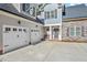 Two-car garage with white doors and stone accents at 1620 Dail Dr, Raleigh, NC 27603