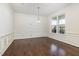 Bright dining room with hardwood floors and wainscoting at 2025 Ginseng Ln, Raleigh, NC 27603