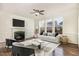 Living room with fireplace and large windows offering backyard view at 2025 Ginseng Ln, Raleigh, NC 27603