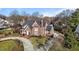 Brick home with circular driveway and landscaped yard, offering curb appeal at 2035 Stuart Ct, Burlington, NC 27215