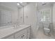 Neutral toned bathroom with a large mirror, single sink vanity and a shower-tub combo at 2035 Stuart Ct, Burlington, NC 27215