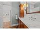 Bathroom vanity with marble countertop, wooden cabinets, stylish lighting, next to entry at 2035 Stuart Ct, Burlington, NC 27215