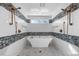 Spa-like bathroom with freestanding tub, double shower heads, and herringbone tile at 2035 Stuart Ct, Burlington, NC 27215