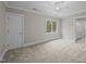 Spacious carpeted bedroom featuring a ceiling fan and ensuite bathroom for added convenience at 2035 Stuart Ct, Burlington, NC 27215