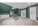 Carpeted room with a treadmill and custom built-in cabinets for maximized storage and organization at 2035 Stuart Ct, Burlington, NC 27215