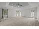 Spacious bedroom with a tray ceiling, neutral carpet, and natural light from windows and doors at 2035 Stuart Ct, Burlington, NC 27215