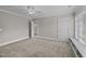 A neutral-toned bedroom with carpet and ensuite access, a ceiling fan and a window seat at 2035 Stuart Ct, Burlington, NC 27215