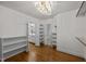 Spacious closet with custom shelves and drawers, chandelier, and an ensuite bathroom at 2035 Stuart Ct, Burlington, NC 27215