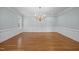 Bright dining room features hardwood floors, chandelier, and neutral wall color, perfect for entertaining guests at 2035 Stuart Ct, Burlington, NC 27215