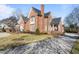 Brick home with a large driveway and mature landscaping at 2035 Stuart Ct, Burlington, NC 27215