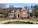 Brick front home with circular driveway and landscaping at 2035 Stuart Ct, Burlington, NC 27215