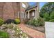 Charming home entrance showcasing beautiful brickwork and vibrant landscaping, a welcoming sight at 2035 Stuart Ct, Burlington, NC 27215