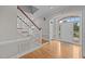 Elegant foyer with hardwood floors, white staircase, and front door, showcasing the home's entry at 2035 Stuart Ct, Burlington, NC 27215
