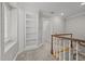 Upstairs hallway with built-in shelving and wood railing at 2035 Stuart Ct, Burlington, NC 27215