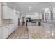 Modern kitchen with white cabinets, granite counters, and island at 2035 Stuart Ct, Burlington, NC 27215