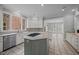 Modern kitchen boasts granite countertops, kitchen island with cooktop, tile backsplash, and ample lighting at 2035 Stuart Ct, Burlington, NC 27215