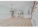 Open-concept living room with view to kitchen, staircase, tile flooring and light blue walls at 2035 Stuart Ct, Burlington, NC 27215