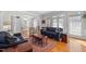 Sunlit living room with hardwood floors, comfortable seating, and large windows at 2035 Stuart Ct, Burlington, NC 27215