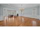 Open-concept living room with hardwood floors, a cozy seating area, and ample natural light at 2035 Stuart Ct, Burlington, NC 27215