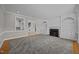 Spacious living room with fireplace, built-in shelving, and seamless transitions to other living spaces at 2035 Stuart Ct, Burlington, NC 27215