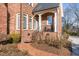Brick side entrance with steps leading to a small porch at 2035 Stuart Ct, Burlington, NC 27215