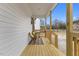 View of a cozy front porch featuring chairs, a small table, and a wooden railing, perfect for relaxation at 210 N Broad St, Burlington, NC 27217