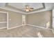 Spacious bedroom with ceiling fan and access to bathroom at 224 Windsor Green Dr, Clayton, NC 27527