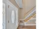 Bright entryway with hardwood floors, staircase, and interior door at 224 Windsor Green Dr, Clayton, NC 27527