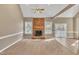 Bright living room featuring a brick fireplace and hardwood floors at 224 Windsor Green Dr, Clayton, NC 27527