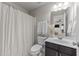 Clean bathroom with shower/tub combo and dark vanity at 2260 Dunlin Ln, Raleigh, NC 27614