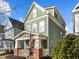 Green two-story house with white trim and a welcoming front porch at 2260 Dunlin Ln, Raleigh, NC 27614