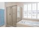 Clean bathroom with a shower and soaking tub at 2328 Carriage Oaks Dr, Raleigh, NC 27614