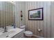 Stylish powder room with updated vanity and decorative wallpaper at 2328 Carriage Oaks Dr, Raleigh, NC 27614