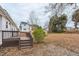Backyard view featuring a wooden deck and leaf-covered ground at 2400 Dorety Pl, Raleigh, NC 27604
