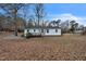 Back exterior view of the home with a wooden deck and a spacious backyard at 2400 Dorety Pl, Raleigh, NC 27604