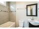 Updated bathroom with a bathtub, toilet and vanity at 2400 Dorety Pl, Raleigh, NC 27604