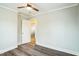Bedroom view showcasing wood-look flooring and an open doorway to another room at 2400 Dorety Pl, Raleigh, NC 27604