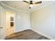 Bedroom showcasing wood-look flooring and an open doorway to the bathroom at 2400 Dorety Pl, Raleigh, NC 27604