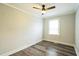 Bedroom features ceiling fan, wood-look flooring, and natural light from a single window at 2400 Dorety Pl, Raleigh, NC 27604